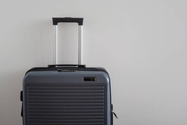 istock larger gray plastic rigid trunk with a retractable telescopic handle. One suitcase prepared for a business trip. 1090422882