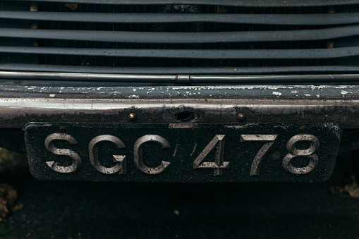 London, UK - July 30, 2018: Old British black number plates with silver characters