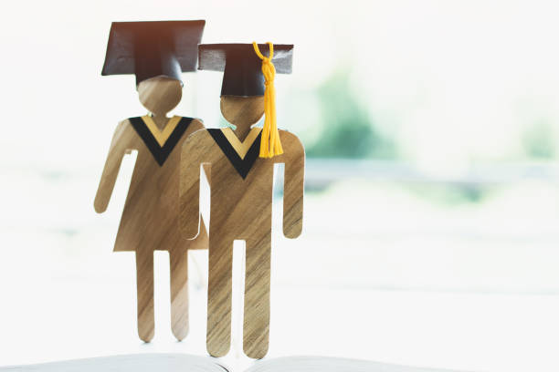 istock Back to School Concept, Two People Sign wood with Graduation celebrating cap on open textbook show alternative studying. Graduate or Education knowledge learning study abroad international Ideas. 1090425426