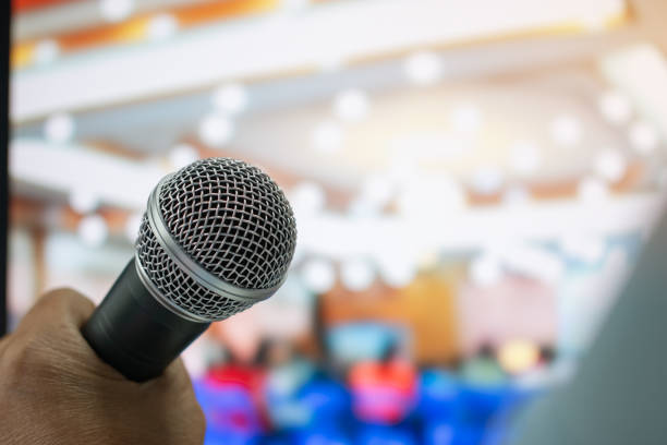 istock Seminar Conference Concept : Microphones for speech or speaking in seminar room, talking for lecture to audience international meeting, Event light convention hall Background. 1090425710