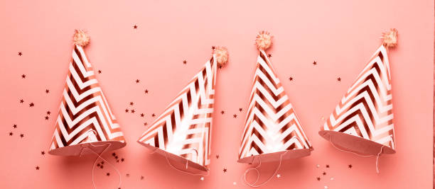 istock Striped golden cones hats and confetti. Banner format 1090428980