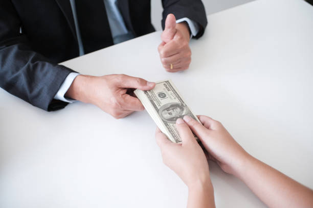 istock Man giving bribe money in envelope businessmen corruption. 1090431104