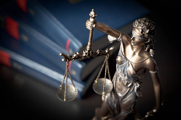 istock Statue of justice on books background 1090431440