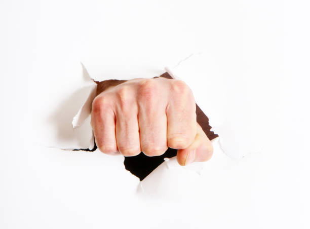 istock The fist passes through the hole. 1090438840