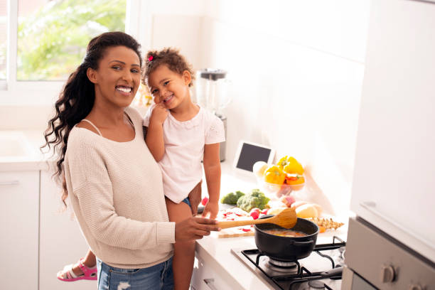 istock Mother and daughter cooking soup together. 1090442916