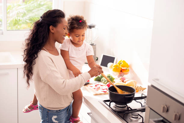 istock Mother and daughter cooking soup together. 1090448230