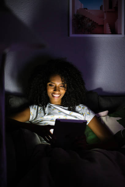 istock Woman in pajamas with a tablet 1090448456