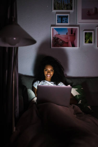 istock Woman in pajamas with a computer 1090448468