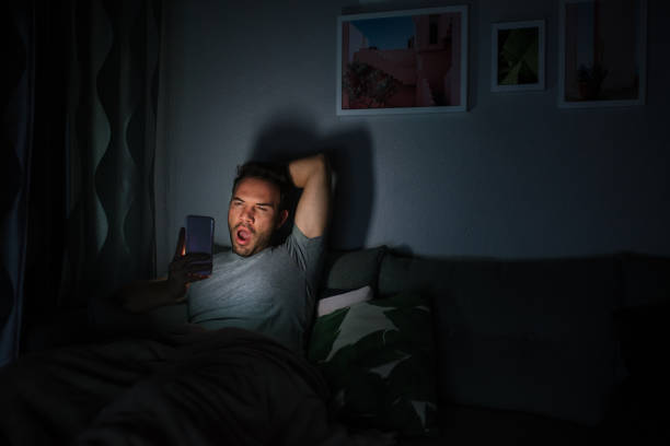 istock Man in pajamas with a mobile phone 1090449094