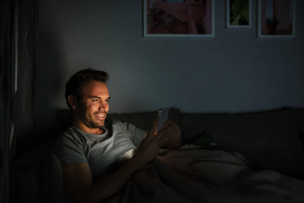 istock Man in pajamas with a mobile phone 1090449432
