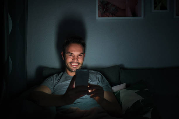 istock Man in pajamas with a mobile phone 1090449530