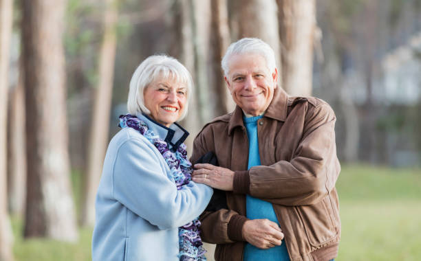 istock Senior couple in park, smiling at camera 1090450528
