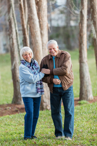 istock Senior couple in park, smiling at camera 1090450644