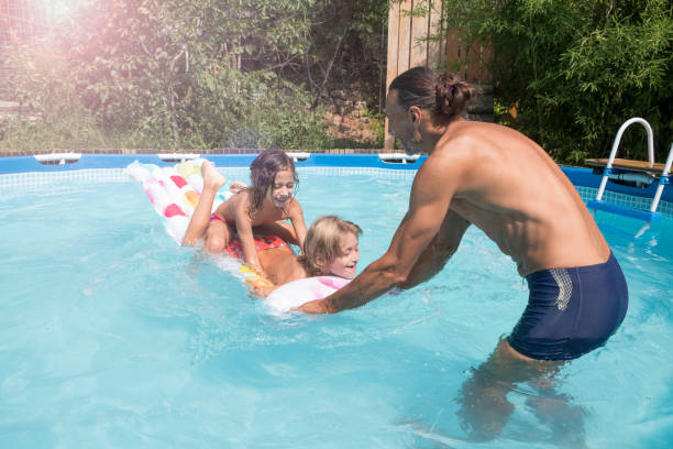 istock Family playing in swimming pool 1090453152