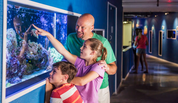 istock Father and his two children at the aquarium 1090455706