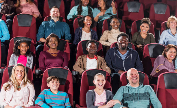 Multi-ethnic audience watching movie in theater