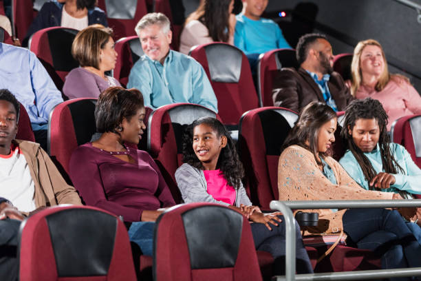 istock Multi-ethnic audience in movie theater, talking 1090458086