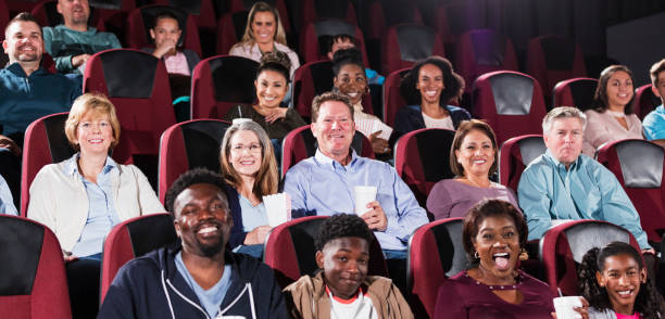 istock Multi-ethnic audience watching movie in theater 1090458092