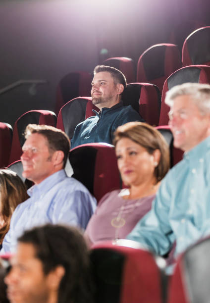 istock Man in movie theater audience, watching alone 1090459388