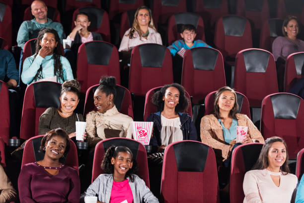 istock Multi-ethnic audience watching movie in theater 1090459874