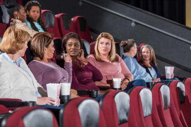 istock Multi-ethnic group in movie theater, mostly women 1090460682