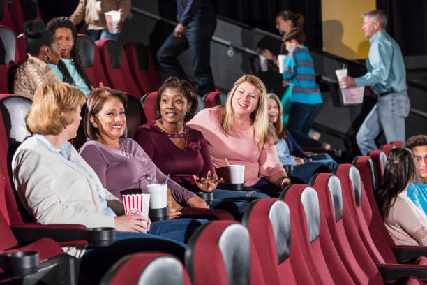 Multi-ethnic group in a movie theater, getting seated