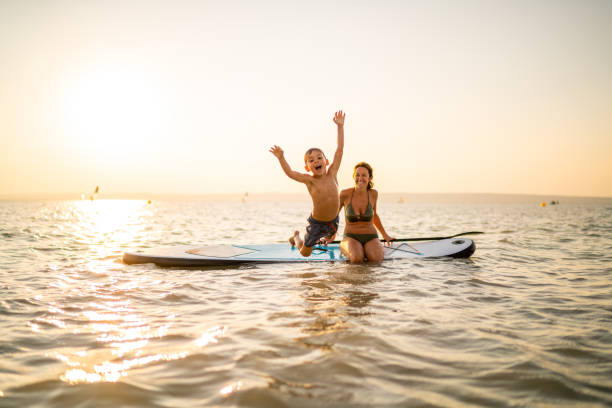 istock happy little boy jumping in lake 1090462856