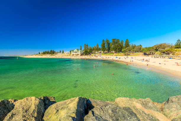 Cottesloe Beach Perth Cottesloe Beach in Western Australia: white sand and calm turquoise waters. The Perth's most famous beach, Indian Ocean. Summertime in blue sky. Copy space. cottesloe beach stock pictures, royalty-free photos & images