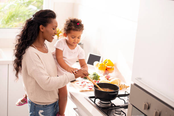istock Mother and daughter cooking soup together. 1090465992