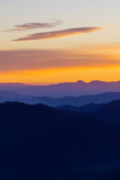 Beautifully colored layers of hills and sky after sunset stock photo