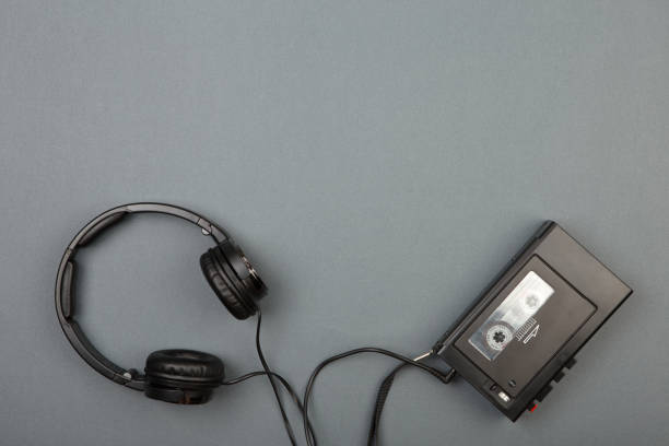 istock Retro cassette player with headphones on grey background 1090468050