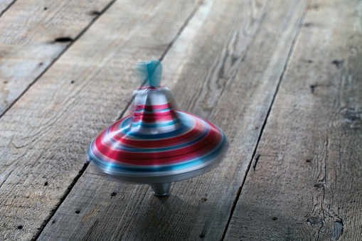 Yule toy spins on wooden floor