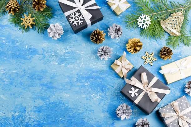 istock Blue Christmas frame with fir branches, black giftboxes, silver and golden decorations 1090474682
