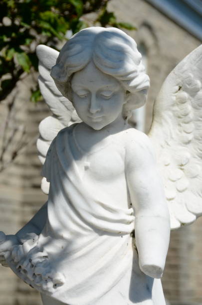istock White stone angel statue in a cemetery 1090475390