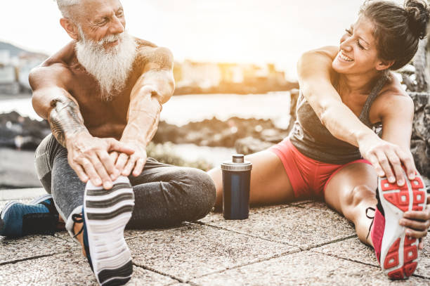 istock Fit couple making stretching before running workout - Joggers training outdoor at sunset together - Main focus on womaman face - Fitness, sport, wellness, workout, gym and healthy lifestyle concept 1090477686