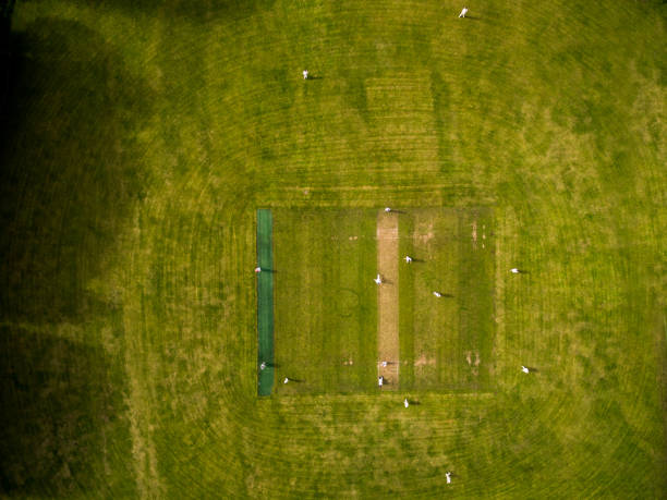 Aerial view of players, playing a game of Cricket on a Welsh Park Pitch in the summer