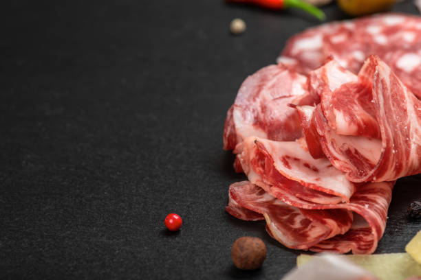 istock antipasto with sliced salami, cheeses, prosciutto, ham on black slate background, copy space 1090484600