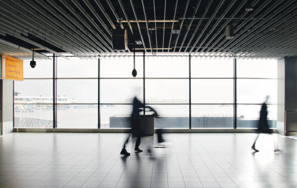 istock Airport passengers crowd walking blurred people 1090484834