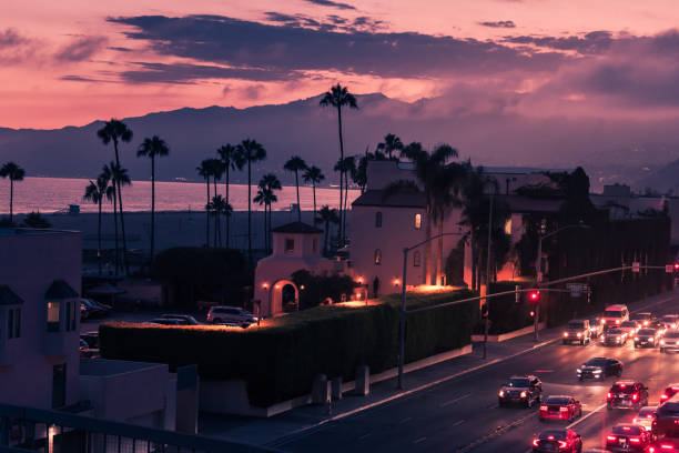 istock Purple sunset in Santa Monica with palms and traffic on freeway 1090487740