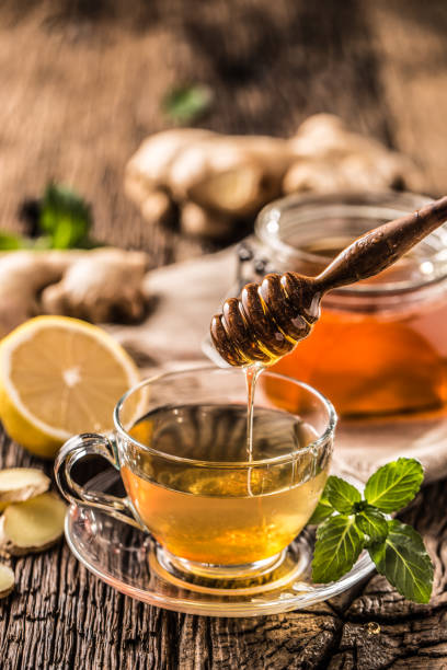 istock Ginger tea honey lemon and mint leaves on wooden table. 1090487756