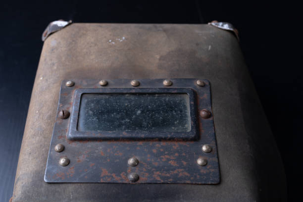 istock An old mask for the welder. Accessories for a production worker. Dark background. 1090487788