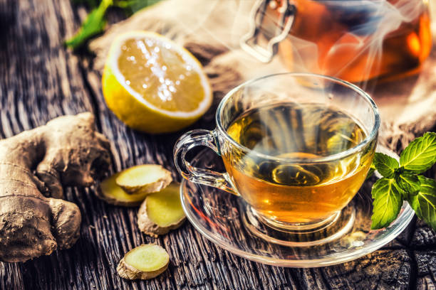 istock Ginger tea honey lemon and mint leaves on wooden table. 1090487838