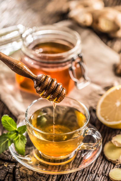 istock Ginger tea honey lemon and mint leaves on wooden table. 1090487842