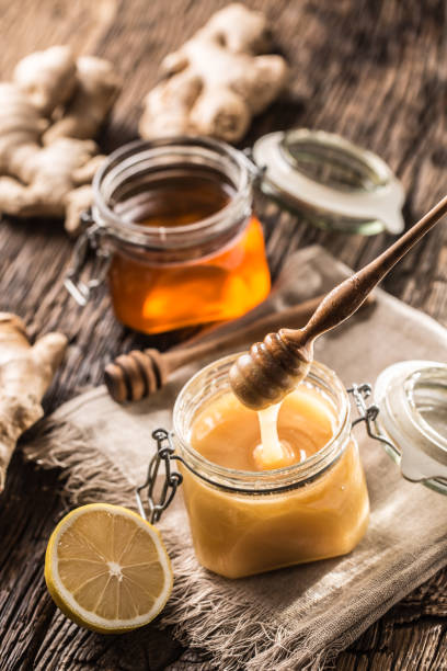 istock Honey in jars and  dipper on rustic oak table. 1090488036
