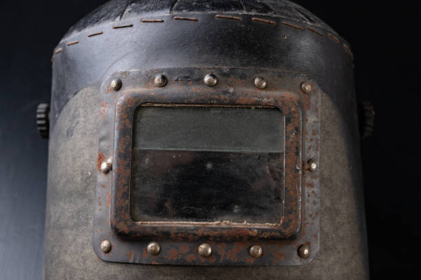 istock An old mask for the welder. Accessories for a production worker. Dark background. 1090489974