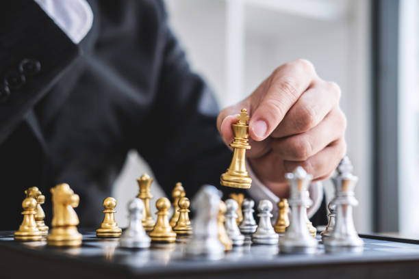 istock Hands of confident businessman playing chess game to development analysis new strategy plan, leader and teamwork concept for win and success 1090491394