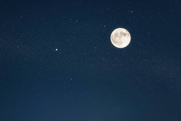 istock Huge full moon on the night sky with bright stars 1090491442