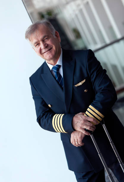 istock Experienced Senior pilot waiting at the airport lobby for flight 1090491626