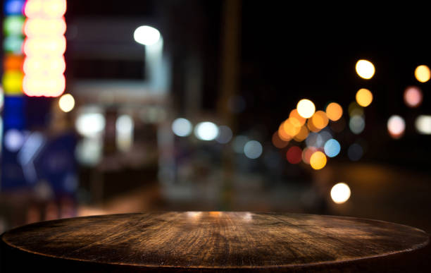 istock Selective Empty wooden table in front of abstract blurred festive light background with light spots and bokeh for product montage display of product 1090491674