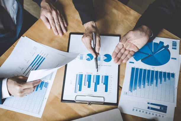 istock Co working conference, Business team colleagues discussing working analysis with financial data and marketing growth report graph in team, Business finances and accounting concept 1090491748